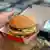 An employee prepares a "Giant" hamburgers at a US fast food Mac Donalds restaurant