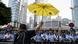 A pro-democracy protester lifts a yellow umbrella in Hong Kong A pro-democracy protester lifts a yellow umbrella in Hong Kong