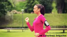 park; smiling; woman; girl; sport; running; smartphone; happy; weight; loss; slimming; warm-up; warming; up; person; people; sportswear; workout; activity; jogging; runner; sporty; aerobics; young; training; athlete; athletic; african; american; black; wellness; health; healthy; lifestyle; train; exercising; fitness; outdoors; earphones; app; application; podcast; playlist; music; radio; phone; cell; power; walk; walking