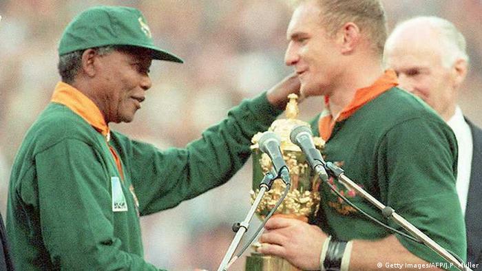 Nelson Mandela handing the world cup trophy to captain Francois Pienaar in 1995