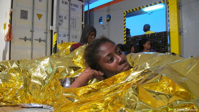 A woman rests on the Argos rescue vessel