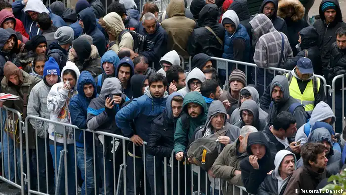 Refugees line up along fences in Germany