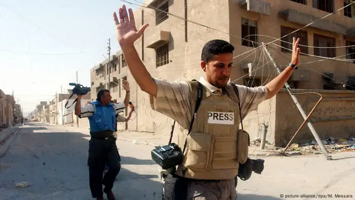 Two Journalists with press written on their clothes