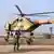 Libyan Army soldiers jump from a helicopter to show their skills as part of a graduation ceremony