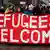 Refugees Welcome sign at a demonstration in Hamburg, Copyright: picture-alliance/dpa/D. Bockwoldt".