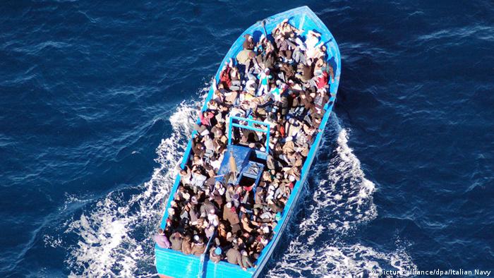 Fully loaded migrant boat in the Mediterranean i