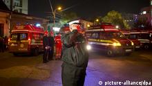CORRECTS TO REMOVE REFERENCE OF EXPLOSION - A policeman stands at the site of a fire that occurred in a club in Bucharest, Romania, early Saturday, Oct. 31, 2015. A heavy metal band's pyrotechnical show sparked a deadly fire Friday at a Bucharest nightclub, killing more than 20 people and injuring scores of the club's mostly youthful patrons, officials and witnesses said. (AP Photo/Vadim Ghirda) Eingestellt von jj