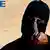IS militant Jihadi John, dressed in all black with his face masked, except for his eyes, and pointing a knife at the camera.