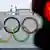 Олимпийские кольца на фоне красного сигнала светофора