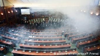 Opposition lawmakers throw tear gas during a session of Kosovo's parliament