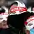 Demonstranten mit Masken (Foto: picture alliance/AP Photo/L. Jin-man)