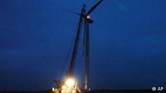 Cranes lifting blades up to wind turbine at an offshore installation