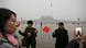 People with national flags have their picture taken just after a flag-raising ceremony amid heavy smog at Tiananmen Square People with national flags have their picture taken just after a flag-raising ceremony amid heavy smog at Tiananmen Square
