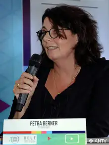 Photo of Petra Berner holding a microphone