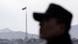 A South Korean soldier stands as North Korea's flag can be seen in the distance. A South Korean soldier stands as North Korea's flag can be seen in the distance.