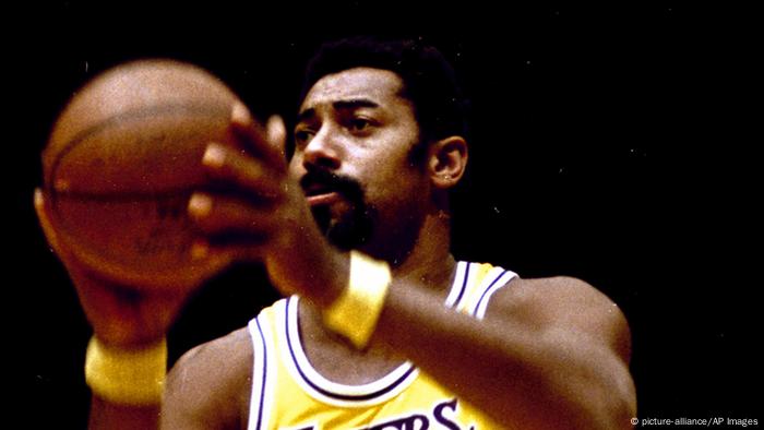 Wilt Chamberlain in the Los Angeles Lakers jersey holds the ball in both hands