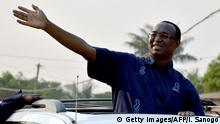 Central African presidential candidate Anicet Georges Dologuele waves from a car in a motorcarde during a presidential campaign tour in Bangui on December 28, 2015, on the last day of campaigning ahead of Central African Republic presidential and legislative elections due December 30. Long-delayed elections in volatile Central African Republic that are key to ending years of brutal sectarian unrest were postponed on December 25 for three days until December 30. / AFP / ISSOUF SANOGO (Photo credit should read ISSOUF SANOGO/AFP/Getty Images)