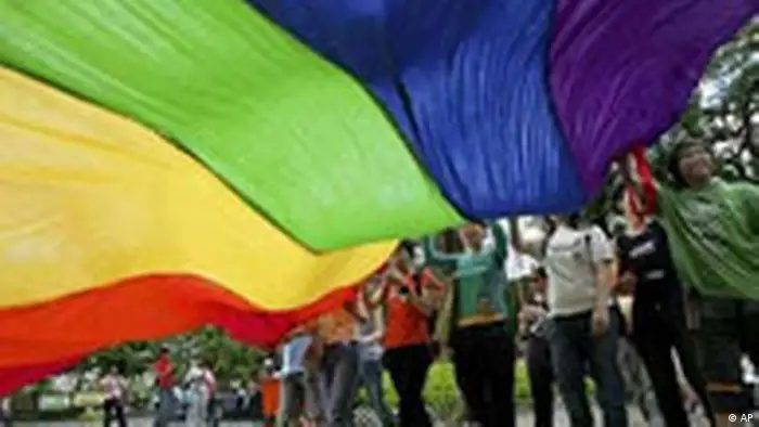 Gay rights campaigners wave rainbow flag during parade in Hong Kong, photo