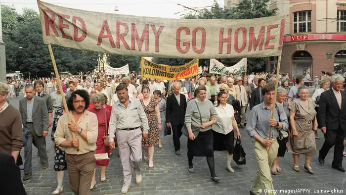 Pro-democracy supporters carry a banner reading 'Red Army Go Home' in Vilnius, Lithuania, in March 1991