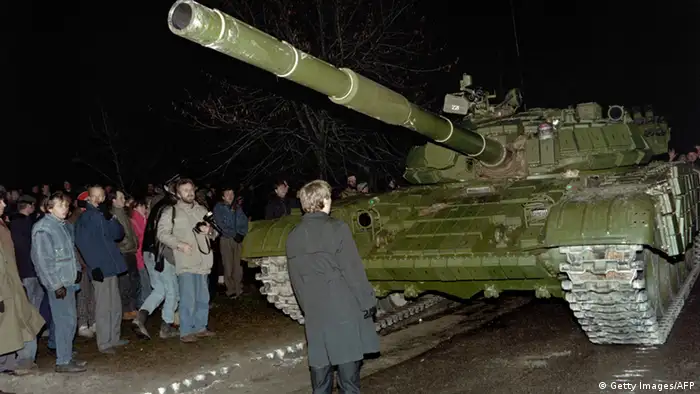 A Lithuanian demonstrator stands in front of a Soviet tank on January 13, 1991, in Vilnius