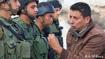 A Palestinian confronts Israeli soldiers during the weekly peaceful demonstration against occupation, Al Ma'sara village, West Bank, March 03, 2012. BY: Ahmad Al-Bazz.