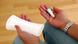 A woman holds a sanitary pad in one hand and a tampon in the other. A woman holds a sanitary pad in one hand and a tampon in the other.