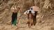 Yemenis carry relief supplies as they walk along a path after Shiite rebels (c) picture-alliance/AP Photo/A. Alseddik Yemenis carry relief supplies as they walk along a path after Shiite rebels (c) picture-alliance/AP Photo/A. Alseddik