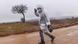 A boy wearing a raincoat walks on a muddy road after crossing the Macedonian border A boy wearing a raincoat walks on a muddy road after crossing the Macedonian border