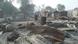People walk past burnt out houses following an attack by Boko haram in Dalori village People walk past burnt out houses following an attack by Boko haram in Dalori village