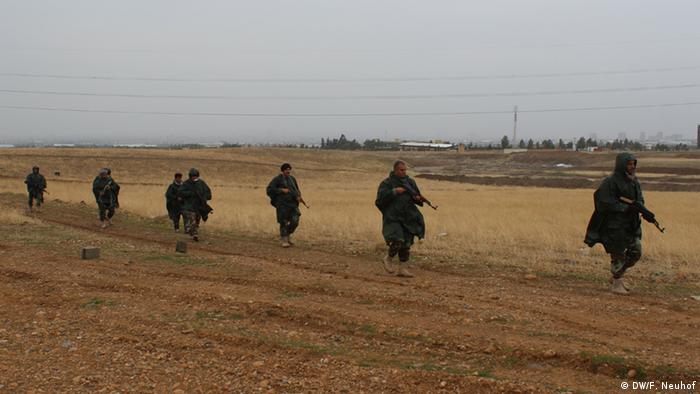 Peshmerga fighters training in a field near Irbil