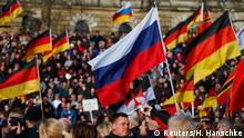 Supporters of the anti-Islam movement Patriotic Europeans Against the Islamisation of the West (PEGIDA) carry German and Russian flags during a demonstration in Dresden, Germany, February 6, 2016. REUTERS/Hannibal Hanschke
