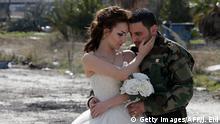 5.2.2016 Newly-wed Syrian couple Nada Merhi,18, and Syrian army soldier Hassan Youssef,27, pose for a wedding picture amid heavily damaged buildings in the war ravaged city of Homs on February 5, 2016. A Syrian photographer thought of using the destruction of Homs to take pictures of newly wed couples to show that life is stronger than death. / AFP / JOSEPH EID (Photo credit should read JOSEPH EID/AFP/Getty Images) Copyright: Getty Images/AFP/J. Eid