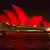 The Sydney Opera House bathed in in red