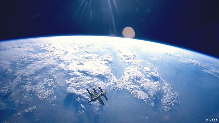 The Russian Space Station Mir, backdropped against Earth as the sun rises (NASA)