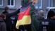Nationalist demonstrators holding a German flag Nationalist demonstrators holding a German flag