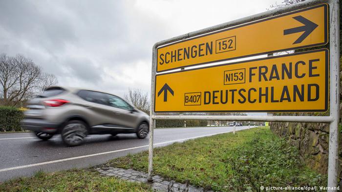 A car passes a road sign near the French-German-Luxembourgish border