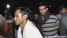 24.02.2016+++ This photograph taken late on February 23, 2016 shows Indian student activist Umar Khalid (C) and Anirban Bhattacharya (L) walking through the campus of New Delhi's Jawaharlal Nehru University (JNU) on their way to surrendering to Indian authorities. Khalid and Bhattacharya are accused of sedition over a rally at which anti-India slogans were shouted. Students have accused Prime Minister Narendra Modi's right-wing nationalist government of misusing the British-era sedition law to stifle dissent. AFP PHOTO / AFP / STRDEL (Photo credit should read STRDEL/AFP/Getty Images) +++ (C) Getty Images/AFP