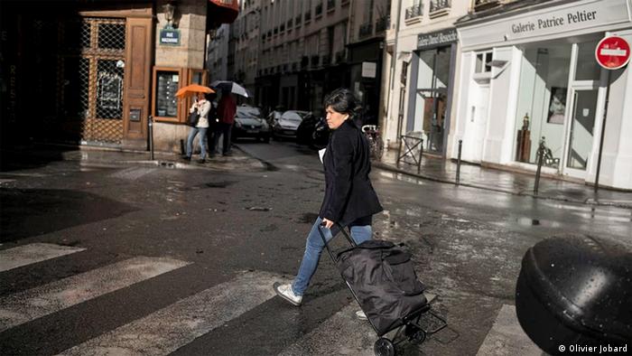 Gemma pulls a trolley on along a Paris street