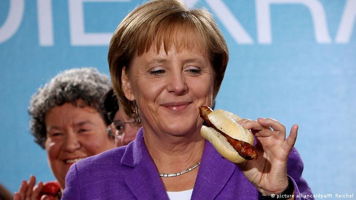 Angela Merkel with a Bratwurst