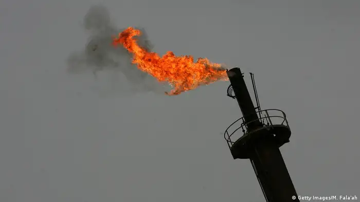 Flame at the top of an oil refinery tower in Iraq