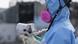 Japan Okuma Fukushima Daiichi Schutzanzug employee uses a a radiation dosage minitor Japan Okuma Fukushima Daiichi Schutzanzug employee uses a a radiation dosage minitor