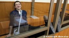 Former Ukrainian army pilot Nadezhda Savchenko smiles from a glass-walled cage during a verdict hearing at a court in the southern border town of Donetsk in the Rostov region, Russia, March 22, 2016. REUTERS/Maxim Shemetov Reuters/M.Shemetov