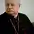 Cardinal Angelo Scola of Milan poses in full religious dress, including a large cross dangling from his neck.
