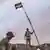 Government troops raise the Syrian flag in Palmyra