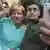 Merkel ao lado de rapaz fazendo selfie 