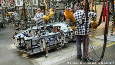 Laborers work at the body welding shop of the Volkswagen factory in Poznan, Poland