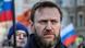 Alexei Navalny during a rally with Russian flags seen in the background