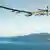Solar Impulse 2 over the sea on the west coast of the USA