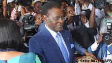 24.04.2016 Equatorial Guinea incumbent president and candidate Teodoro Obiang Nguema (C)and his wife Constancia Mangue (back) arrive at the polling station on April 24, 2016 in Malabo during the presidential election vote. Africa's longest-serving leader, President Teodoro Obiang Nguema Mbasogo, was set to extend his 36-year-hold on power as the tiny oil-rich nation of Equatorial Guinea went to the polls. / AFP / STR (Photo credit should read STR/AFP/Getty Images) Copyright: DW/R. Graça
