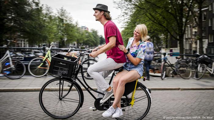 Netherlands Amsterdam 2 people on bike